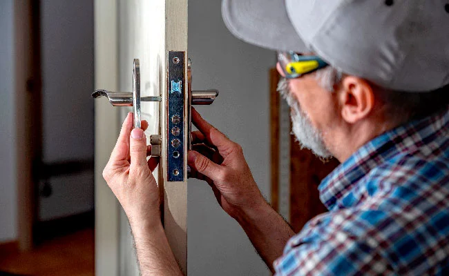Technician installing new lock hardware