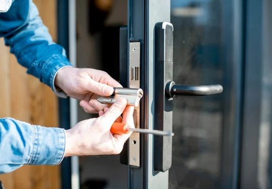 A technician rekeys a commercial door