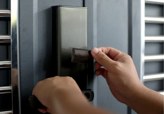 A person unlocks a door with a digital keycard