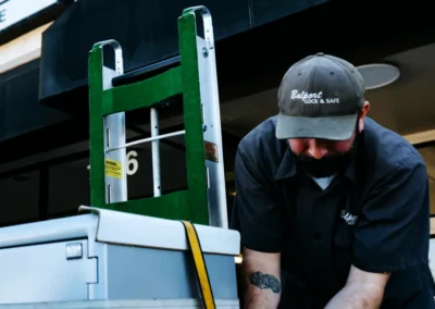 A worker straps a safe for transport