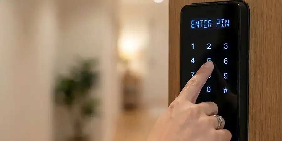 A woman uses a keypad to enter an apartment